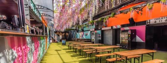 The covered garden walkway, lined with benches and food traders